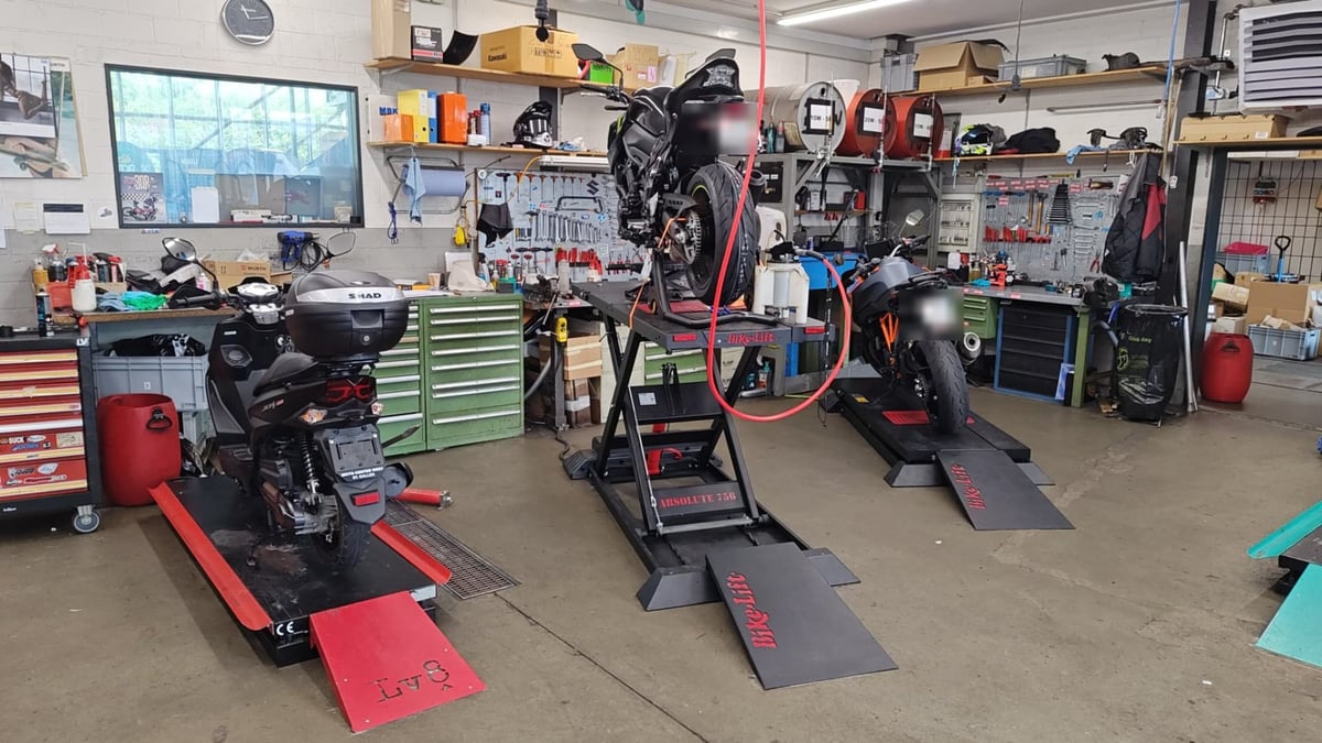 Werkstatthalle von Moto-Center WEST in St. Gallen mit drei Hebebühnen, Roller, Naked Bike und KTM